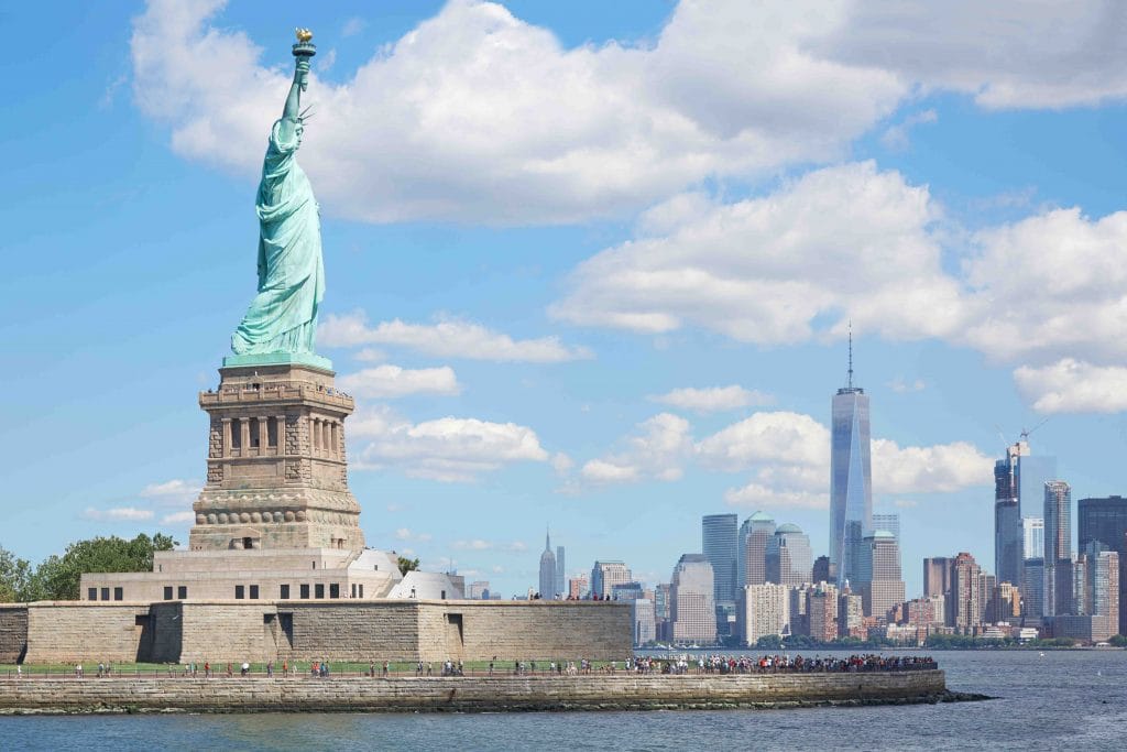 Statue of Liberty with NYC skyline behind.