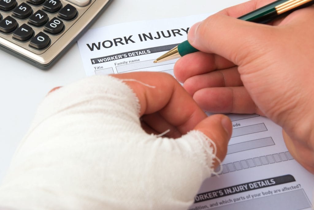 Injured person filling work injury claim form