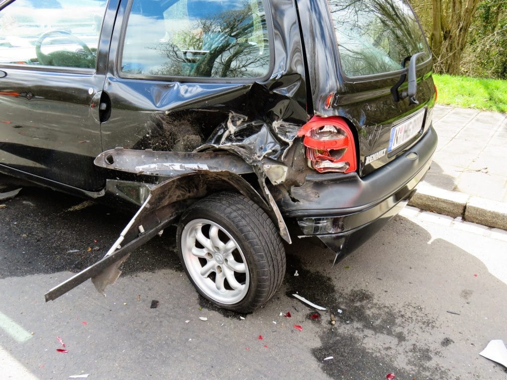 Damaged car after rear-end accident on street
