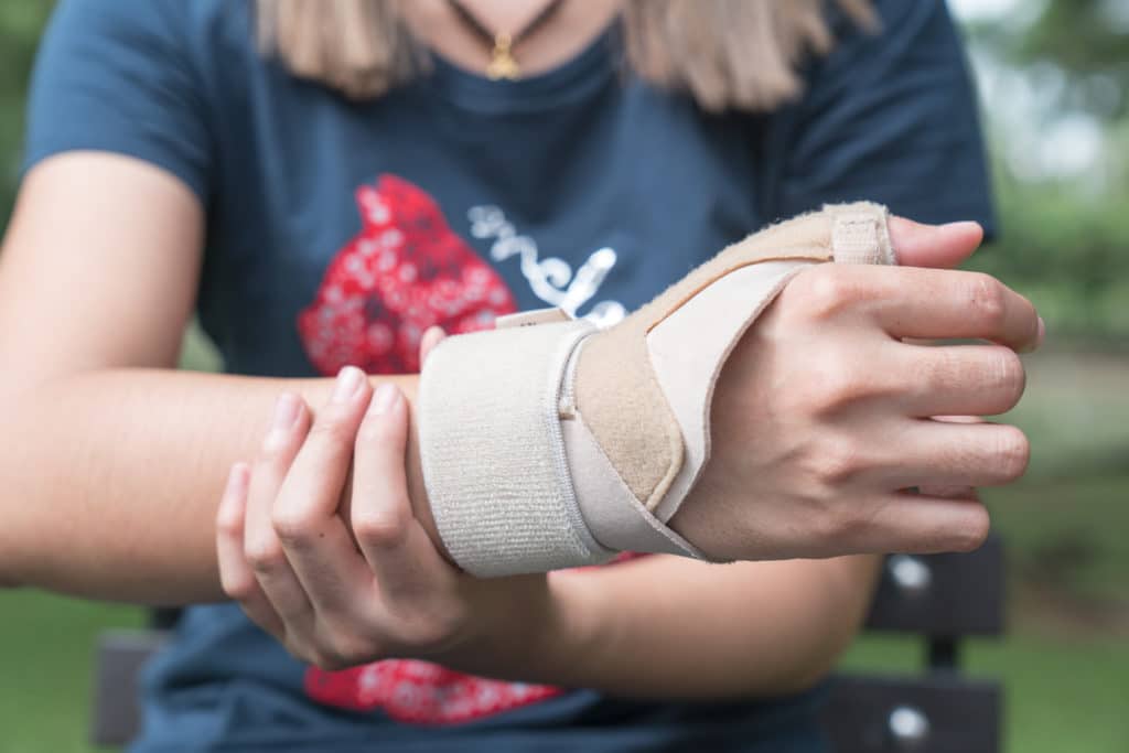 Person wearing wrist brace outdoors