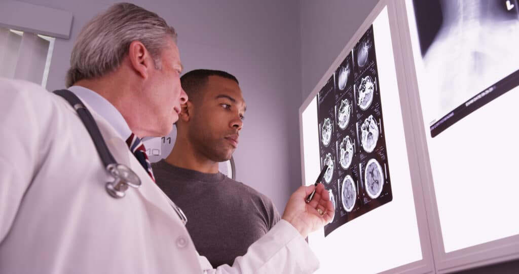 Doctor reviewing brain scans with a patient.