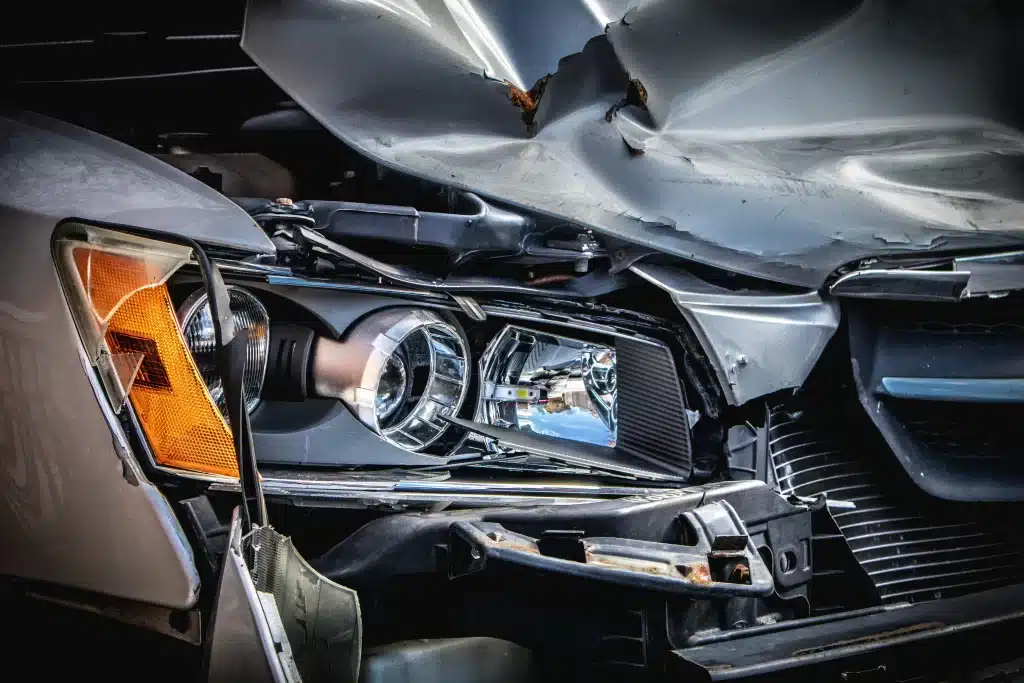 Close-up of damaged car front after collision.